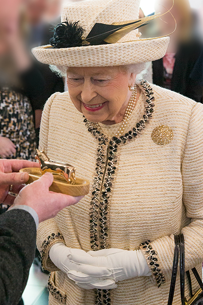Queen Elizabeth II looking at object